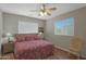 Comfortable primary bedroom features wood floors, a ceiling fan, and a large window with great light at 2416 N Snead Dr, Mesa, AZ 85215