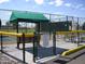 This pickleball court is fenced for safety and features a shaded spectator area at 2416 N Snead Dr, Mesa, AZ 85215