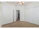 Bright bedroom with a ceiling fan, neutral carpeting, and a large closet with sliding doors at 2454 E Vermont Dr, Gilbert, AZ 85295