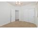 A carpeted bedroom featuring a ceiling fan and closet space at 2454 E Vermont Dr, Gilbert, AZ 85295