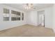Bright bedroom with a ceiling fan, carpeted floor, and large windows for plenty of natural light at 2454 E Vermont Dr, Gilbert, AZ 85295