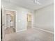 Neutral bedroom features carpet and a connecting view to the bathroom at 2511 W Queen Creek Rd # 307, Chandler, AZ 85248
