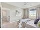 The bedroom features an ensuite bathroom, ceiling fan, and carpet flooring at 2511 W Queen Creek Rd # 307, Chandler, AZ 85248