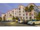 Exterior building view featuring parking spaces and palm trees with beautiful architecture at 2511 W Queen Creek Rd # 307, Chandler, AZ 85248
