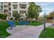 Inviting common area with benches, pathways, green grass, and trees near residential buildings and lush landscaping at 2511 W Queen Creek Rd # 307, Chandler, AZ 85248