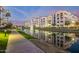 Beautifully landscaped community featuring a tranquil canal with fountains at twilight at 2511 W Queen Creek Rd # 307, Chandler, AZ 85248