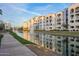 Scenic community lake with a water fountain, lush green grass, and residential buildings reflecting on the water's surface at 2511 W Queen Creek Rd # 307, Chandler, AZ 85248