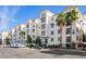 Modern condominium building with balconies and lush landscaping in a vibrant community setting on a clear, sunny day at 2511 W Queen Creek Rd # 307, Chandler, AZ 85248