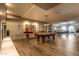 This spacious game room is complete with a pool table and a ping pong table with beautiful wood-look tile flooring at 2511 W Queen Creek Rd # 307, Chandler, AZ 85248
