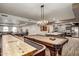 Expansive game room featuring a shuffleboard table, pool table, and kitchenette area at 2511 W Queen Creek Rd # 307, Chandler, AZ 85248