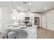 Modern kitchen with white cabinetry, stainless steel appliances, pendant lighting, and a breakfast bar at 2511 W Queen Creek Rd # 307, Chandler, AZ 85248