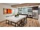 Beautiful kitchen with stainless steel appliances, tile backsplash and large marble countertop dining table at 2511 W Queen Creek Rd # 307, Chandler, AZ 85248