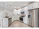 Contemporary kitchen featuring white cabinets, stainless steel appliances, and stylish backsplash at 2511 W Queen Creek Rd # 307, Chandler, AZ 85248