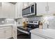 Close-up of the kitchen featuring stainless steel appliances, range, and subway tile backsplash at 2511 W Queen Creek Rd # 307, Chandler, AZ 85248