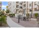 Outdoor grill and dining area with tables and chairs, set against a landscaped building facade at 2511 W Queen Creek Rd # 307, Chandler, AZ 85248
