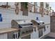 Stainless steel outdoor grills in a community grilling area with tile surround and a lush tropical landscape at 2511 W Queen Creek Rd # 307, Chandler, AZ 85248