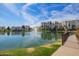Picturesque view of a community pond, complete with a fountain and residential buildings at 2511 W Queen Creek Rd # 307, Chandler, AZ 85248