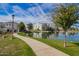 View of community pond with walkway and building reflections at 2511 W Queen Creek Rd # 307, Chandler, AZ 85248