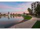 Picturesque pond with fountains, lush landscaping, and upscale residential buildings at 2511 W Queen Creek Rd # 307, Chandler, AZ 85248