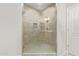 Shower featuring tile surround, glass door, and modern fixtures at 2511 W Queen Creek Rd # 307, Chandler, AZ 85248