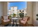 Balcony featuring decorative chairs with a view of the community's buildings at 2511 W Queen Creek Rd # 323, Chandler, AZ 85248