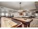 Spacious game room with a pool table, shuffleboard, and a nearby community kitchen at 2511 W Queen Creek Rd # 323, Chandler, AZ 85248