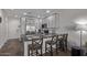 Well-equipped kitchen with stainless steel appliances, gray cabinetry, and a breakfast bar at 2511 W Queen Creek Rd # 323, Chandler, AZ 85248