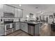 Bright kitchen with stainless steel appliances, a breakfast bar, and an open layout to the living area at 2511 W Queen Creek Rd # 323, Chandler, AZ 85248