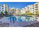 Resort-style pool with palm trees and ample seating for relaxation and enjoyment under the sun at 2511 W Queen Creek Rd # 323, Chandler, AZ 85248