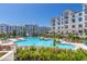 Enjoy the community pool with ample seating, clear skies, and lush landscaping at 2511 W Queen Creek Rd # 323, Chandler, AZ 85248