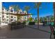 Community poolside outdoor patio and kitchen area with lounge seating and dining tables at 2511 W Queen Creek Rd # 323, Chandler, AZ 85248