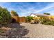 A private backyard featuring desert landscaping and mature trees at 26057 W Sequoia Dr, Buckeye, AZ 85396