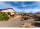 Private backyard with a hot tub, patio area, and gravel landscaping for easy upkeep at 26057 W Sequoia Dr, Buckeye, AZ 85396