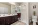 Bathroom featuring a double sink vanity and a separate shower with glass door at 26057 W Sequoia Dr, Buckeye, AZ 85396