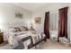 Comfortable bedroom featuring a queen bed, plush bedding, and warm natural light at 26057 W Sequoia Dr, Buckeye, AZ 85396