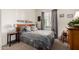 Cozy bedroom with a queen-size bed, a comfortable chair, and natural light from the window at 26057 W Sequoia Dr, Buckeye, AZ 85396