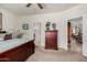 Comfortable bedroom featuring a large bed and a glimpse into the en-suite bathroom and hallway at 26057 W Sequoia Dr, Buckeye, AZ 85396
