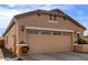 Close-up of two car garage featuring stone accents on stucco exterior under blue skies at 26057 W Sequoia Dr, Buckeye, AZ 85396
