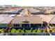 An aerial view of a backyard with a covered patio, artificial grass, manicured landscaping, and a trampoline at 26199 S 227Th St, Queen Creek, AZ 85142