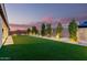 Large backyard with artificial turf, pavers, and manicured landscaping at 26199 S 227Th St, Queen Creek, AZ 85142