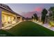 Spacious backyard with manicured landscaping, covered patio, and artificial turf at 26199 S 227Th St, Queen Creek, AZ 85142