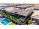 This aerial shows a backyard oasis featuring a sparkling pool, putting green, manicured lawn, and covered patio at 26199 S 227Th St, Queen Creek, AZ 85142