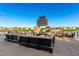 Community outdoor lounge area with a fireplace, comfortable seating, and lakeside views at 26199 S 227Th St, Queen Creek, AZ 85142