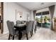 Elegant dining room with upholstered chairs, wood table, and sliding glass doors to the patio at 26199 S 227Th St, Queen Creek, AZ 85142