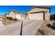 Charming house with attached three car garage, beautifully landscaped front yard, and inviting walkway at 26199 S 227Th St, Queen Creek, AZ 85142