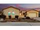 Charming home featuring stucco siding, a tile roof, and desert landscaping during a beautiful sunset at 26199 S 227Th St, Queen Creek, AZ 85142