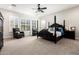 Spacious main bedroom featuring a four-poster bed, sitting area, and large windows with shutters at 26199 S 227Th St, Queen Creek, AZ 85142