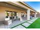Inviting covered patio featuring stylish seating, a patterned rug, and a well-manicured backyard at 26199 S 227Th St, Queen Creek, AZ 85142