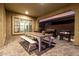 Inviting covered patio with a wooden picnic table and outdoor grill at 26199 S 227Th St, Queen Creek, AZ 85142