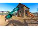 Community playground features a playhouse with slides and a soft landing zone at 26199 S 227Th St, Queen Creek, AZ 85142